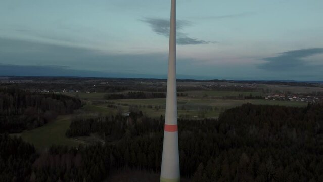 Wind turbine with rotor located in rural environment by the Alps in the district Ebersberg in Bavaria. The 10h rule prevents the construction of modern renewable and sustainable energy. Aerial drone