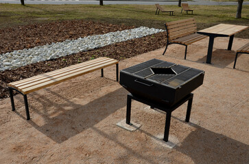 Pergola, garden pavilion is equipped with a metal grill. public barbecue place in the park. wooden...