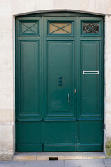 green door home entrance wooden double doors painted in Paris