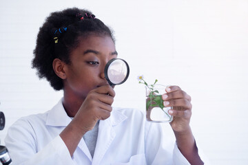 African American girl student making experiments in the laboratory. Child and science, Education.