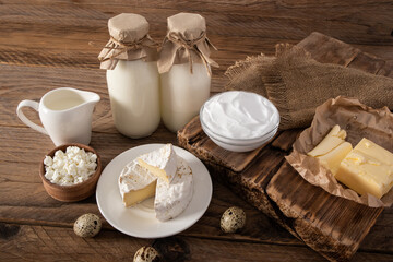 farmer's natural dairy products in assortment on a rustic wooden table. the concept of consumption of natural food.