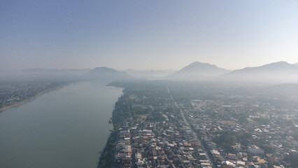Aerial view of Chiang Khan Old Village during misty morning by drone. Village along the Mekong River are Thai-Laos border, which is now a famous tourist attraction of Loei Province Thailand.