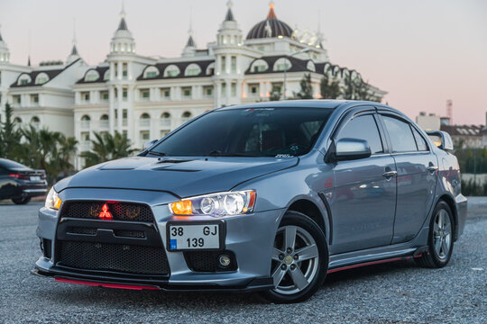Side, Turkey &ndash; February 02 2022:  silver Mitsubishi Lancer    is parked  on the street on a warm  autumn  day against the backdrop of a street, hotel