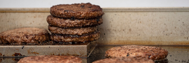 Panorama of burgers cooking on the grill of a fast food truck