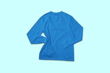 Blue long sleeve t shirt top view with creative flat lay concept