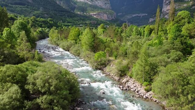 Rio Ara River at Torla, Ordesa Valley, Huesca, Pyrenees, North Spain - Aerial Drone View (Revealing) of Flowing Water, Green Valley and Dark Mysterious Mountains