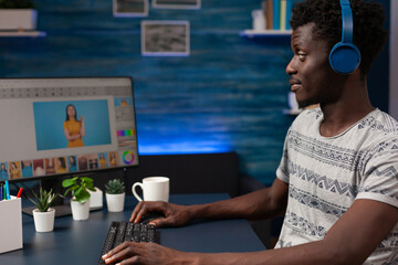 Photographer artist man sitting at desk retouching photo editing contrast using post production...