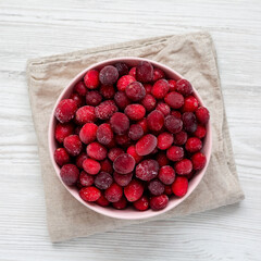 Frozen Cranberries in a Pink Bowl, top view. From above, flat lay, overhead.