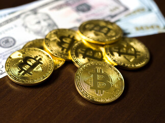 Cryptocurrency bitcoin close-up, in the background american dollars