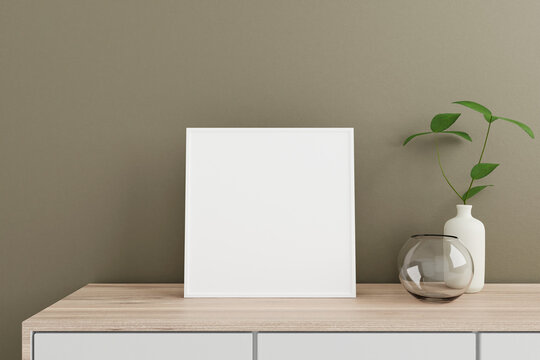 Minimalist and clean square white poster or photo frame mockup on the wooden table in living room with vase and plant