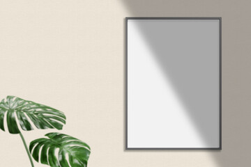 Minimalist hanging vertical black poster or photo frame mockup in living room wall with plant.