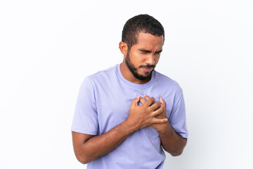 Young Ecuadorian man isolated on white background having a pain in the heart