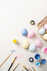 easter background with eggs with pastel paints, top view flat lay