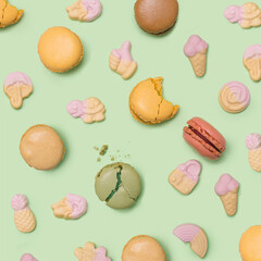 Patisserie yummy artisan concept. Many macarons, in mix with soft pop gummy sweets with different colors and taste. Flat lay green awesome background.