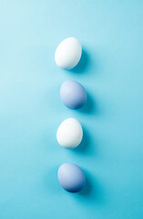 Pastel colored easter eggs on blue background