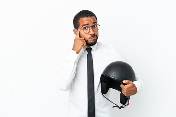 Naklejka premium Young business latin man with a motorcycle helmet isolated on white background thinking an idea
