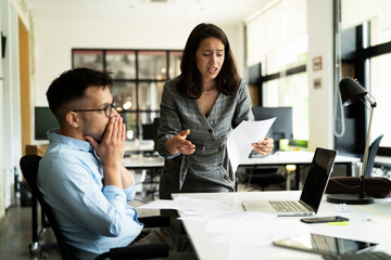 Colleagues arguing in office. Angry businesswoman yelling at her collegue.