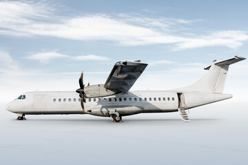 White passenger turboprop aircraft with an open staircase ladder isolated on bright background with sky