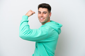 Young caucasian man isolated on white background doing strong gesture