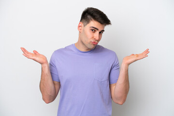 Fototapeta premium Young caucasian man isolated on white background having doubts while raising hands