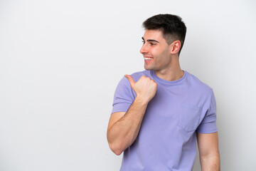 Young caucasian man isolated on white background pointing to the side to present a product