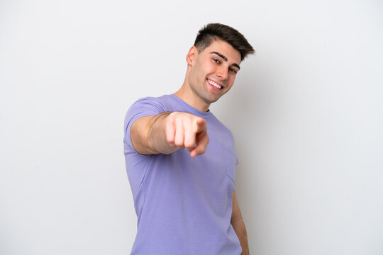Young caucasian man isolated on white background pointing front with happy expression