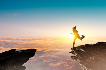 Woman running against sunset sky