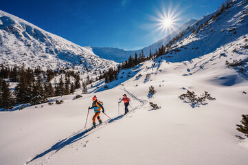 Mountaineer backcountry ski walking ski alpinist in the mountains. Ski touring in alpine landscape...