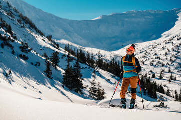 Mountaineer backcountry ski walking ski alpinist in the mountains. Ski touring in alpine landscape...