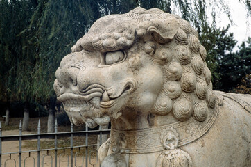 Ornate stone-carved Chinese warrior statues in a park near the Ming Tombs, northwest of Beijing, China. Lion