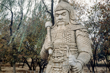 Ornate stone-carved Chinese warrior statues in a park near the Ming Tombs, northwest of Beijing, China. Warrior