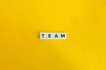 Team Word on Letter Tiles on Yellow Background. Minimal Aesthetics.