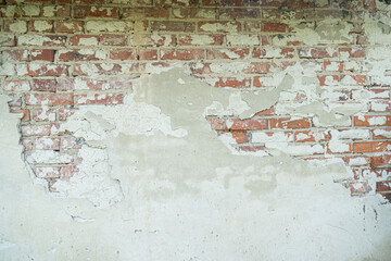 Background of old vintage grunge loft wall with cracked plaster texture.