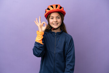 Little caucasian girl isolated on purple background showing ok sign with fingers
