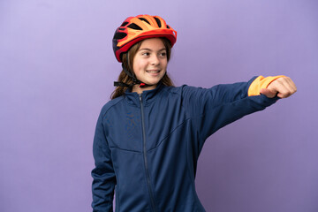 Little caucasian girl isolated on purple background giving a thumbs up gesture