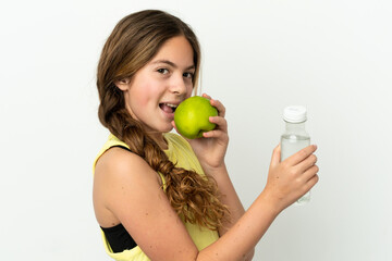 Little caucasian girl isolated on white background with an apple and with a bottle of water