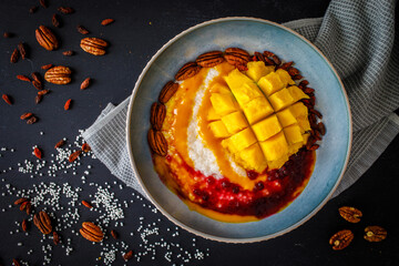 Mango and tapioca dessert on black wooden table