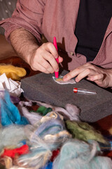Felt crafting - a man's hands doing felting at the 'have a go' felting craft stall