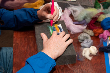 Felt crafting - a man's hands doing felting at the 'have a go' felting craft stall