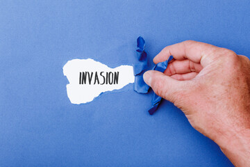 Invasion message on Paper torn ripped opening