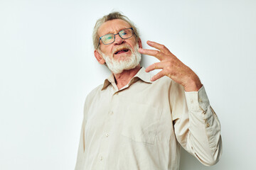 Portrait of happy senior man with a gray beard in a shirt and glasses unaltered