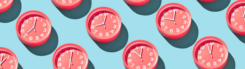 Round alarm clocks showing different times banner