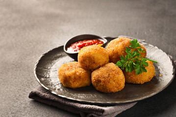 Balls POTATO CROQUETTES and sauce close-up