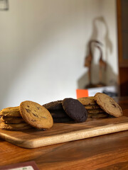 Chocolate chip cookies and chocolate cookies set on wooden platform