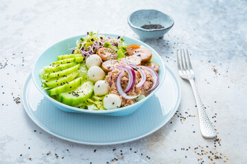 Fresh green mixed salad bowl with tuna, mozzarella and microgreens