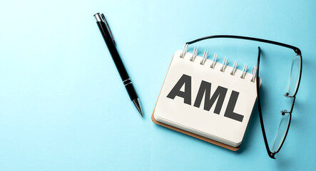 AML text written on a notepad on the blue background