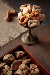 Dried figs in an old brass dish.