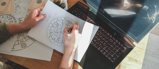 Astrology. Astrologer calculates natal chart and makes a forecast of fate.Tarot cards, Fortune telling on tarot cards magic crystal, occultism, Esoteric background. Fortune telling,tarot predictions.