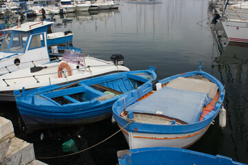 evocative image of fishing boats moored in the harbor in a small fishing village in Sicily, Italy
