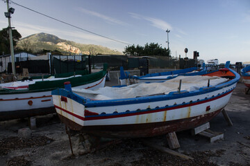 Fototapeta na wymiar evocative image of fishing boats moored in the harbor in a small fishing village in Sicily, Italy 